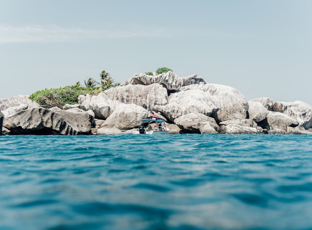a person is surfing on a large rock formation