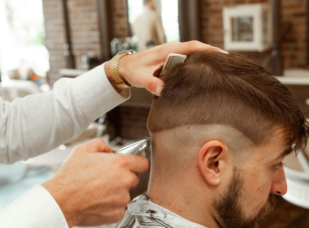 Man styling a fade haircut at home with pomade — West Springs Landing Barbershop Calgary