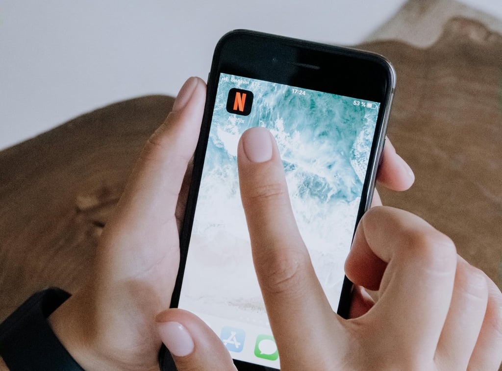 a person holding a cell phone in their hand