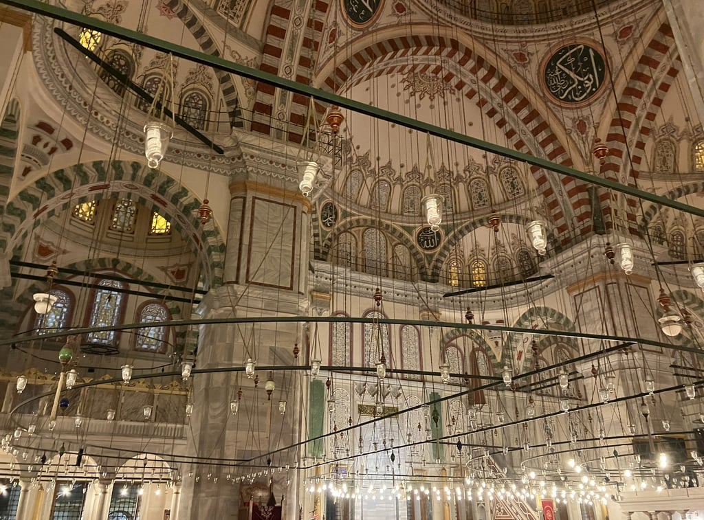 a large mosque interior with lights Fatih Istanbul