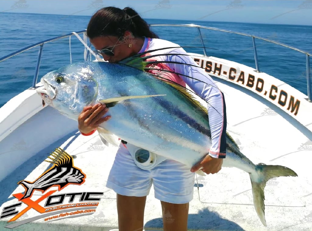 a woman holding a fish fish on a boat