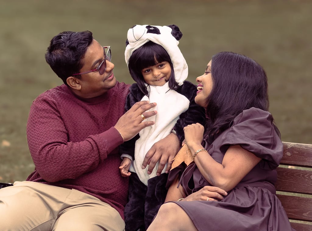 a man and woman sitting on a bench in a park