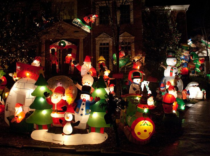 yard full of christmas lights and inflatable decorations