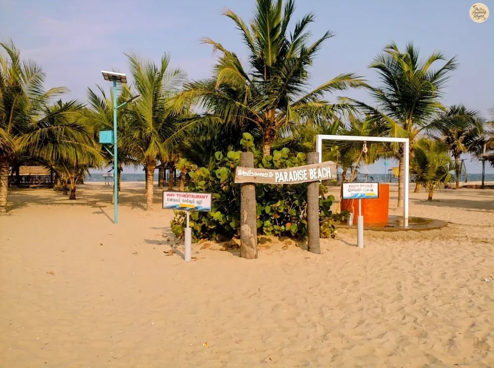 Paradise Beach Pondicherry with golden sand and calm blue waves.