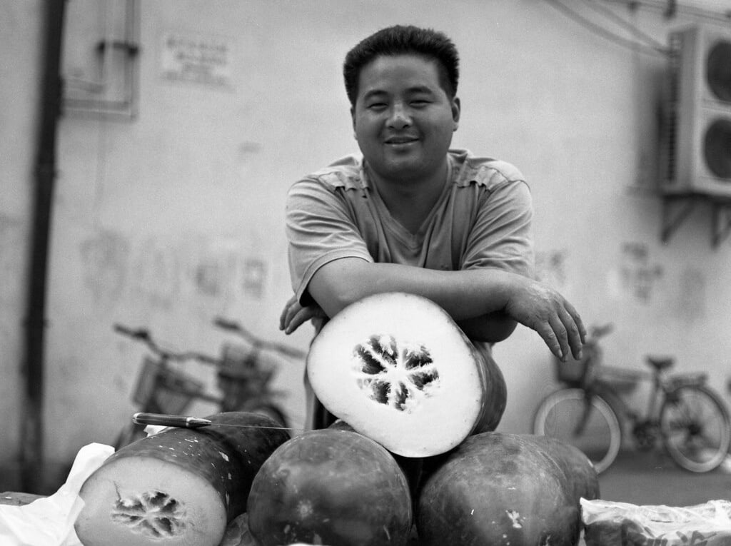 Man in Shanghai selling winter melons at a market