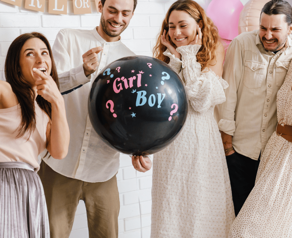 a group of people standing around a balloon - shaped balloon