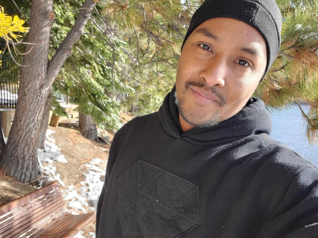 Picture of Wil with snow on the ground near lake tahoe with a black hoodie and beanie