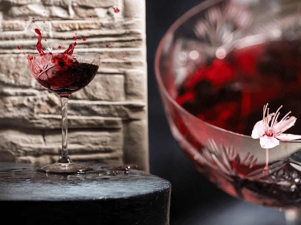 Calice di vino rosso in splash creativo fotografato da Gaudife a Bologna – still life emozionale per brand artigianali.
