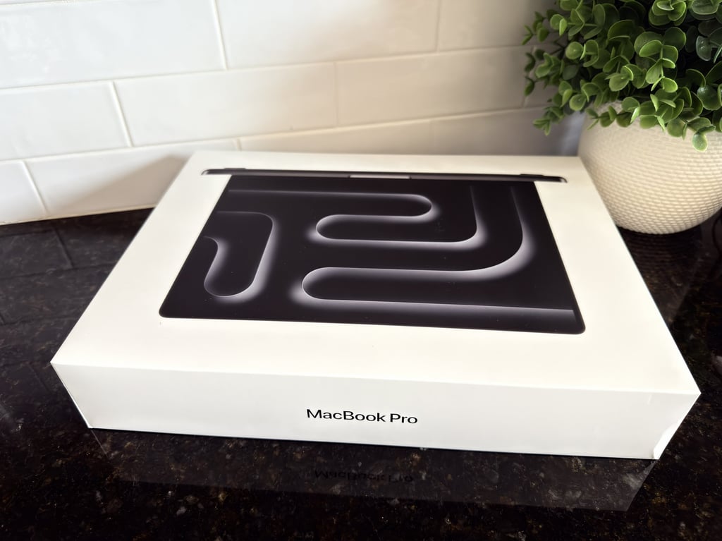 MacBook Pro box on a kitchen counter beside a green plant for a fresh digital upgrade