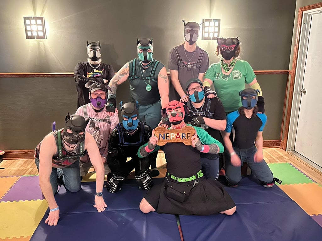 A group photo of people in pup masks. 