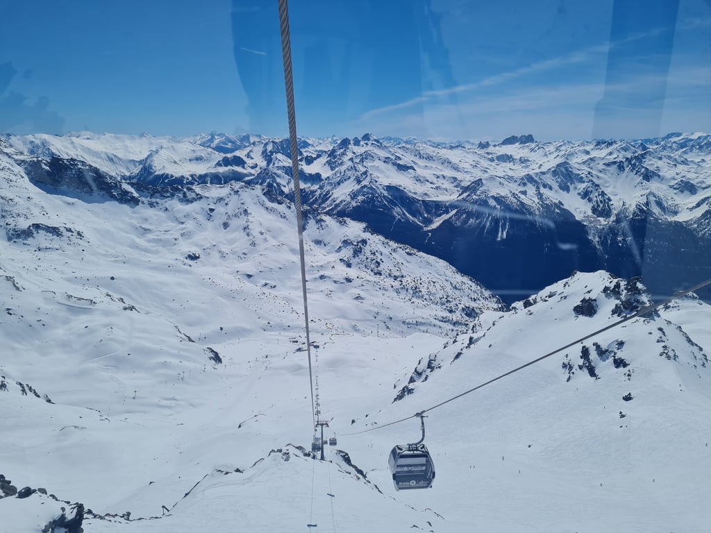 View of ski lifts and snowy slopes in the Val Thorens 3 Valleys ski area