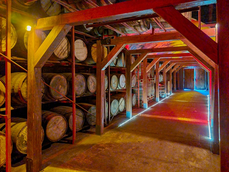 Oak barrels aging Dominican rum inside a distillery warehouse
