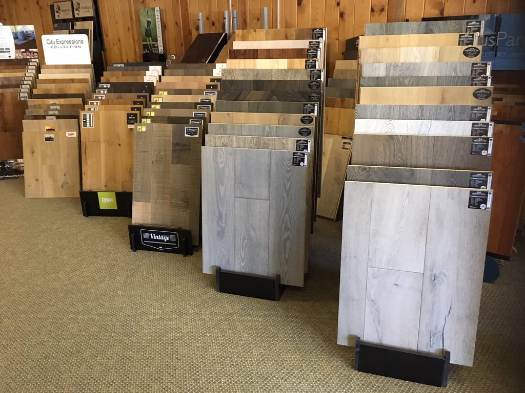 Flooring showroom displaying hardwood, laminate, tile, and vinyl flooring options.