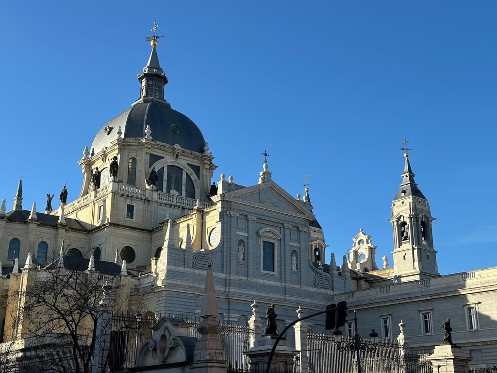 Almudena Cathedral at sunset, a Gothic cathedral with a blue sky behind