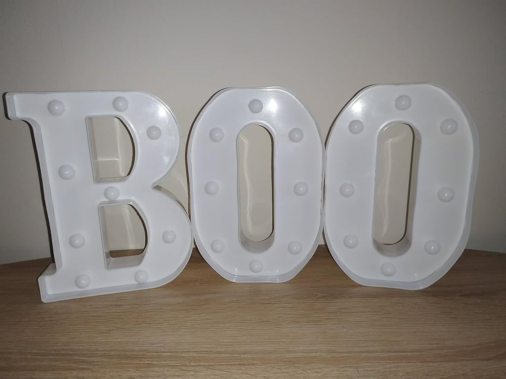 White LED marquee letters spelling "BOO" with glitter finish, perfect Halloween decoration for home,