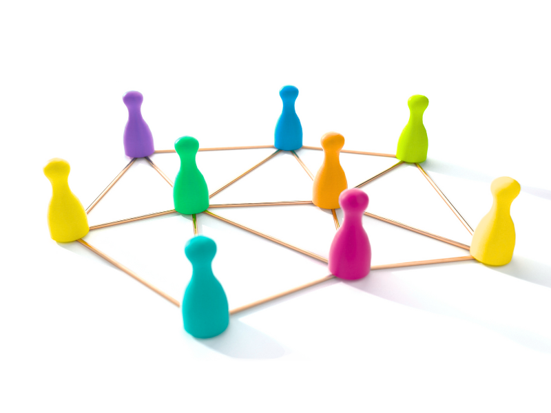 a group of colorful colored board game pawns in a circle connected by golden lines