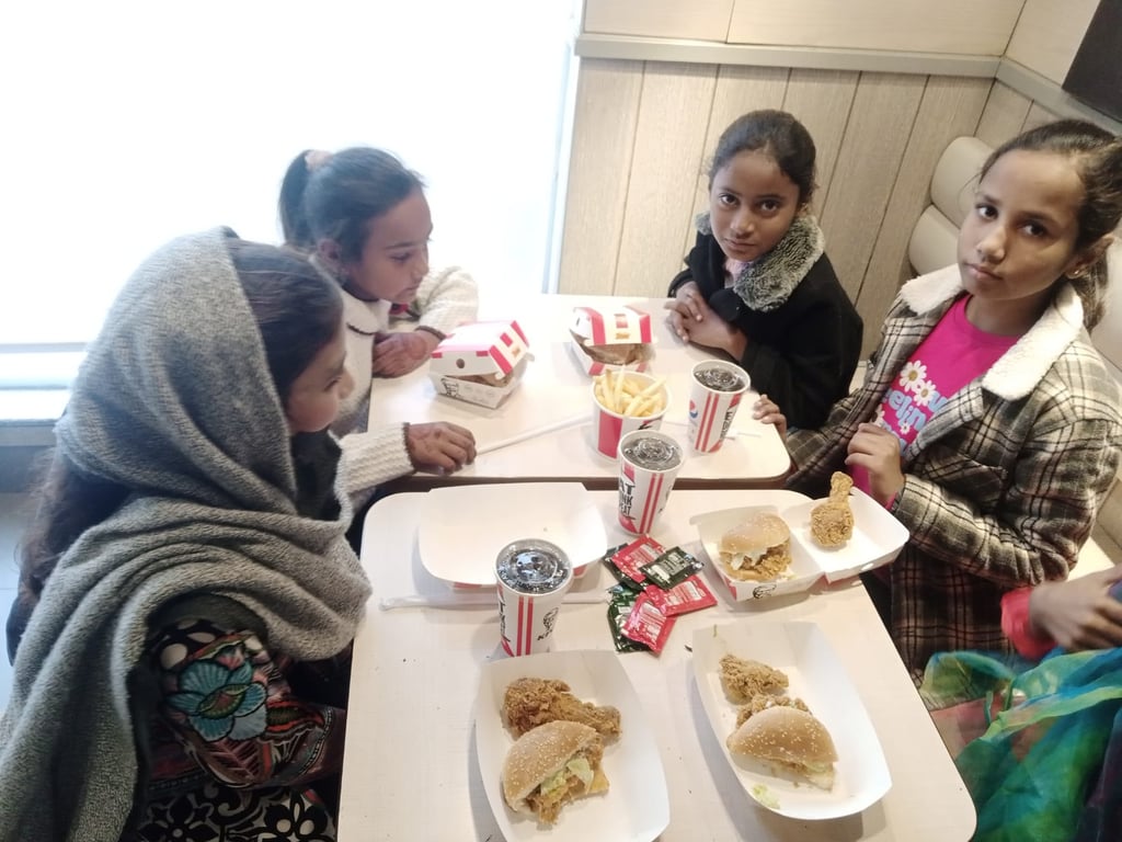 Sunday School children at Water of Life Ministries having lunch burgers and drinks