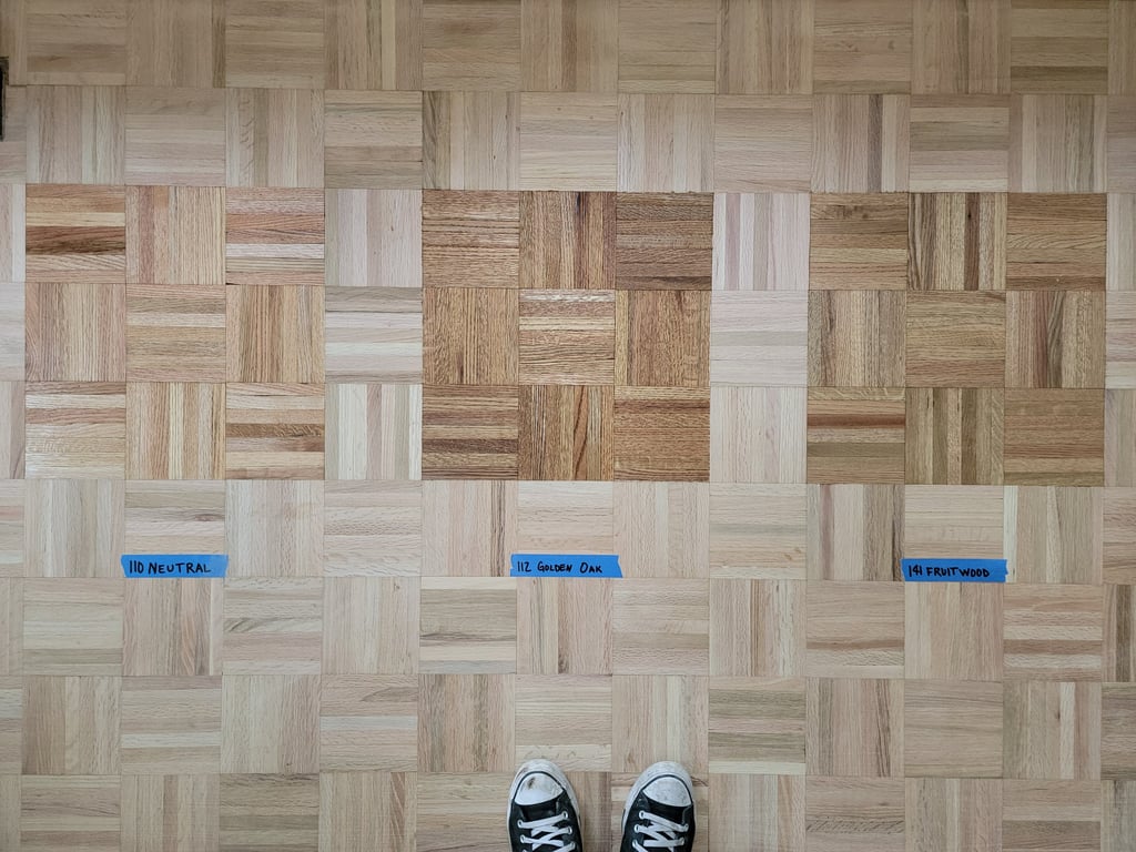 Stain samples on recently sanded parquet flooring.