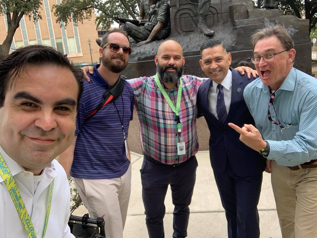 Francisco and communications team smile with Commissioner Julian Alvarez outside