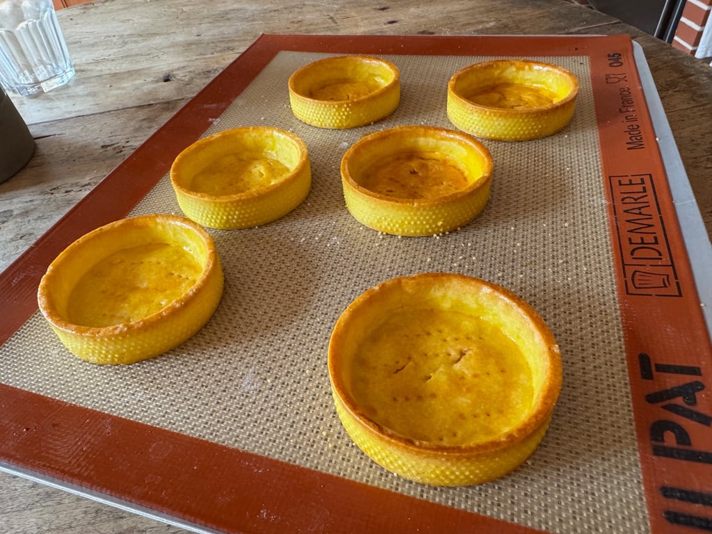 a baking tray with a tray of baked baked baked potatoes and cheesecake