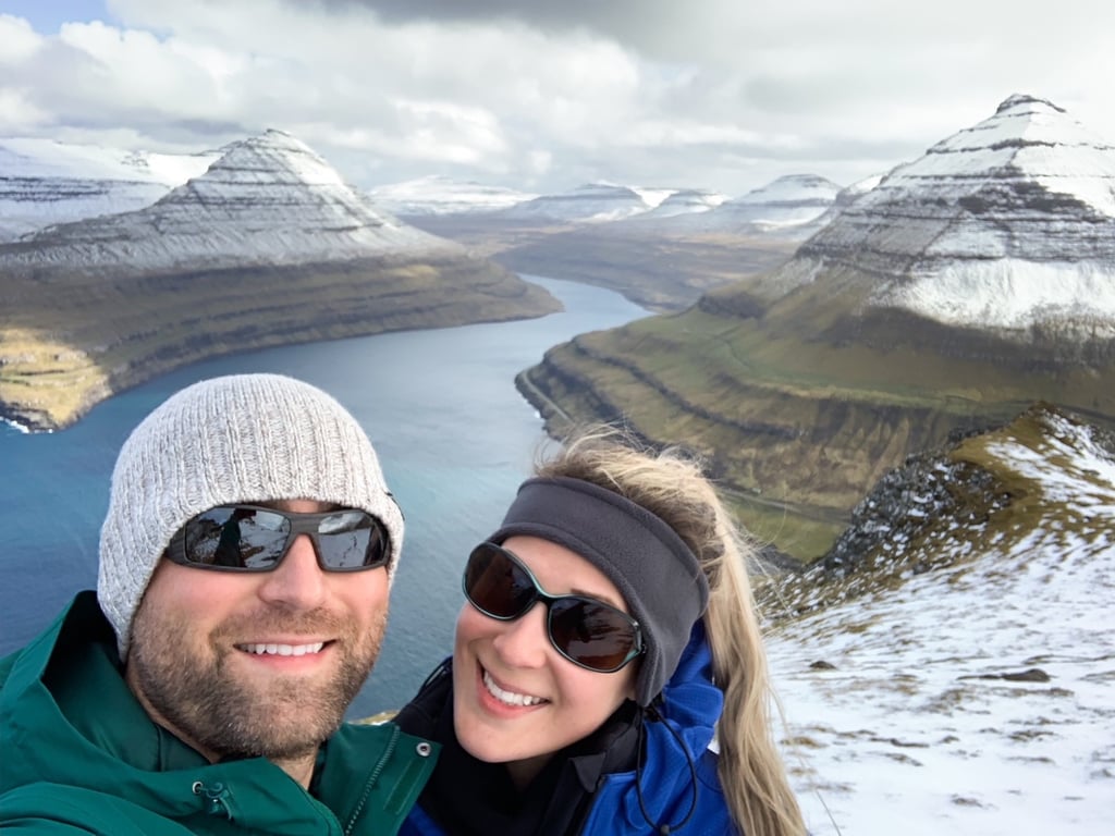 A smiling couple with a mountain vista behind them