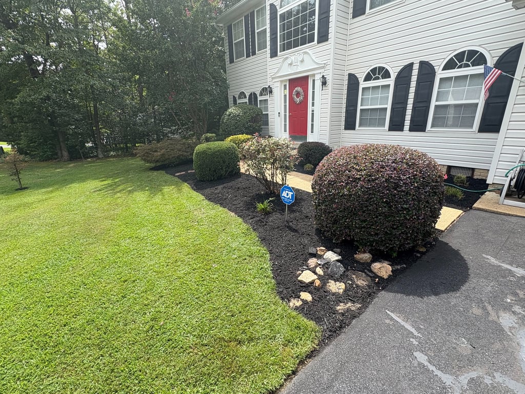 Mulch and decorative rock bed installation with custom flower bed design and edging for a Southern M