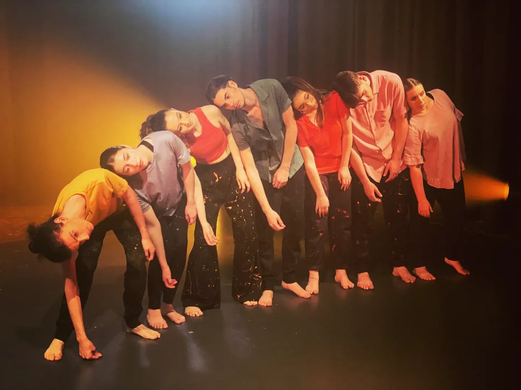 a group of people standing in a line of dancers