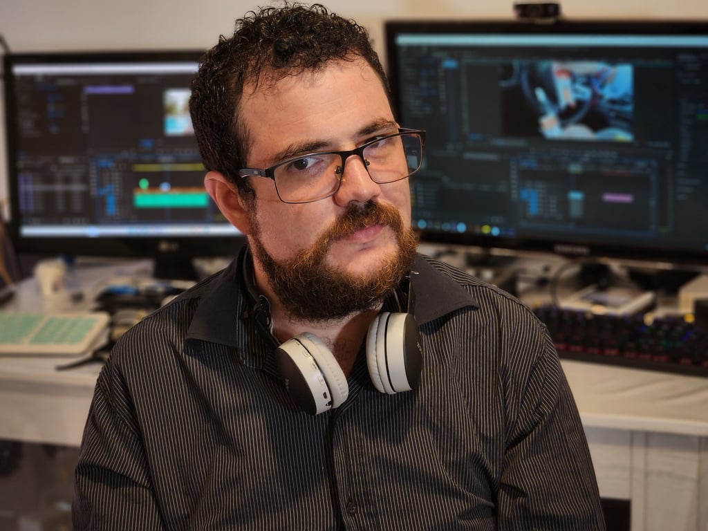 a man with a beard and headphones on a desk