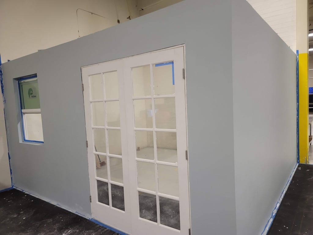a room with a large white door and a blue wall