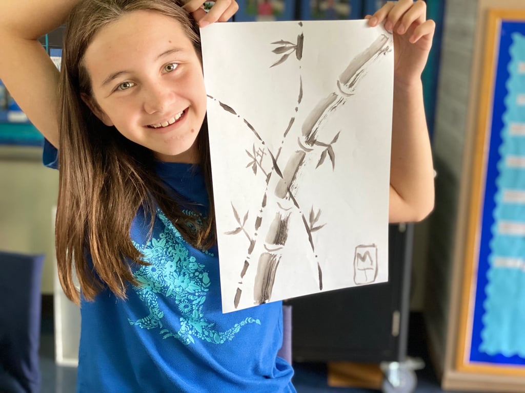 student demonstrating a brush painting