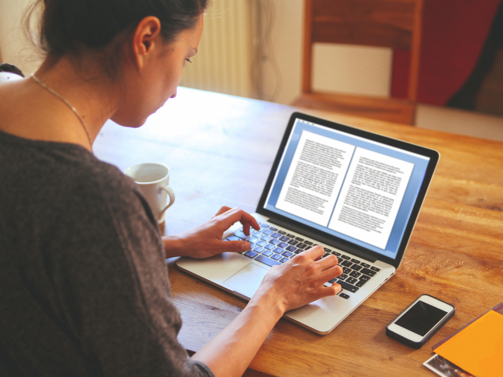 A woman editing a document on a laptop