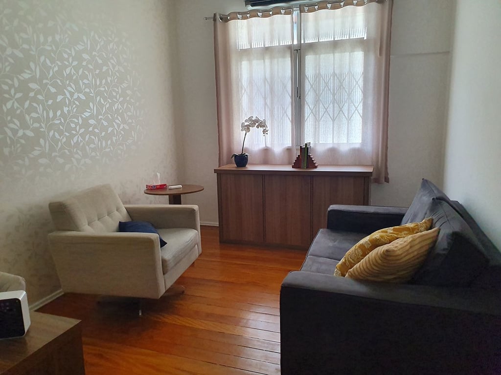 consultório de psicologia com sofá e janela