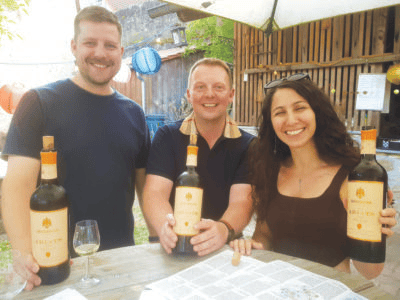 Three people display Armenian wines. (Photo courtesy of E. Drayss)