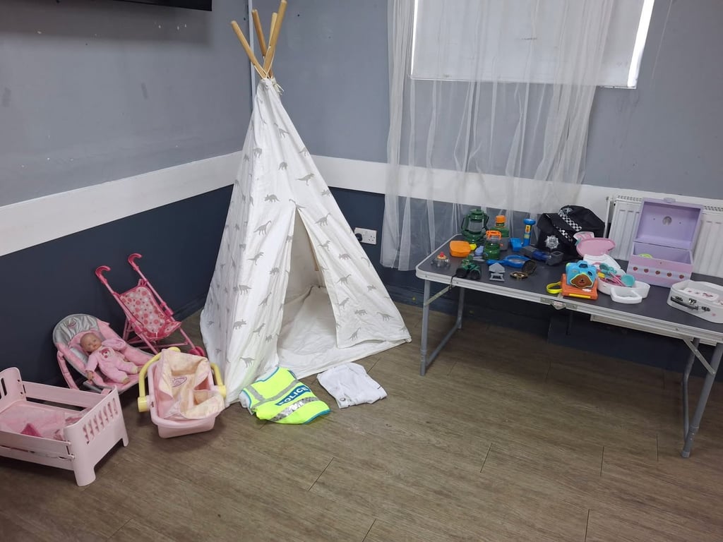 Dolly and dress up corner with teepee and role play toys at SWTFC baby and toddler group