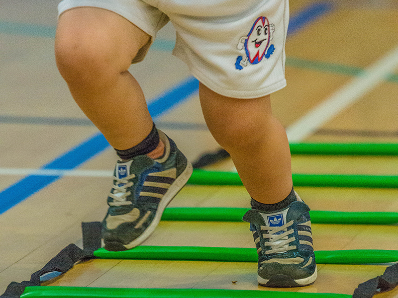 Toddler taking part in Ruggerbugs sports class in Saffron Walden indoor hall