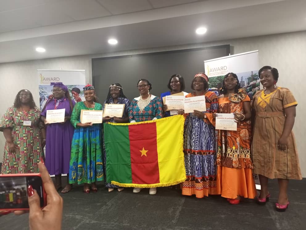 a group of people holding up certificates and holding certificates