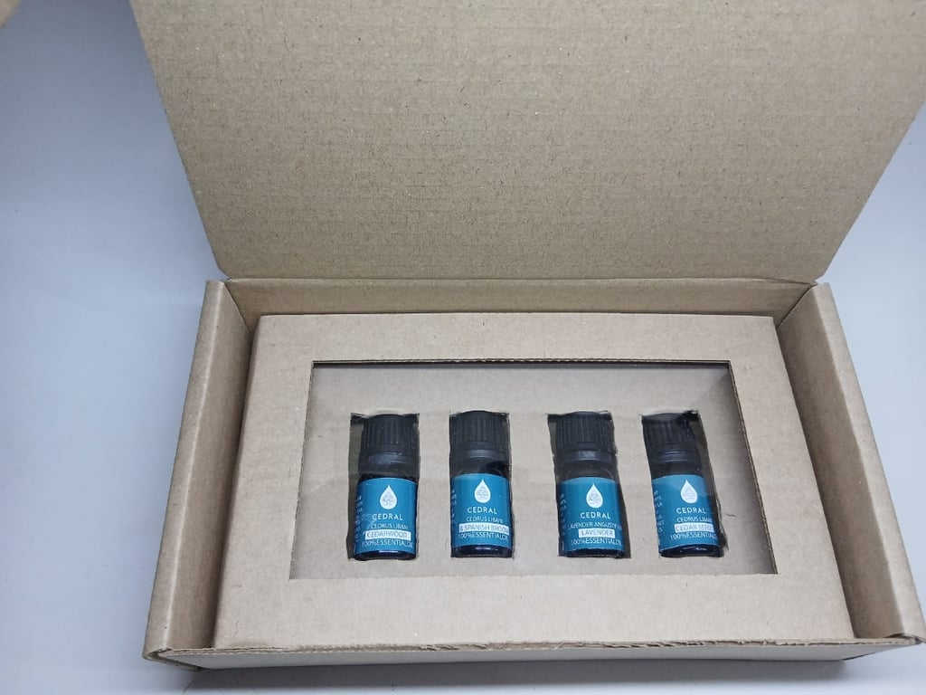 A set of four Cedral 100% pure essential oil bottles in a cardboard gift box for aromatherapy.