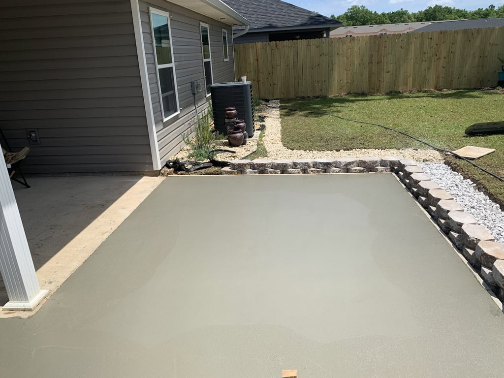 Custom concrete patio installation with clean finish and decorative border design
