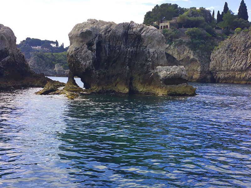 a rock formation in the middle of a body of water