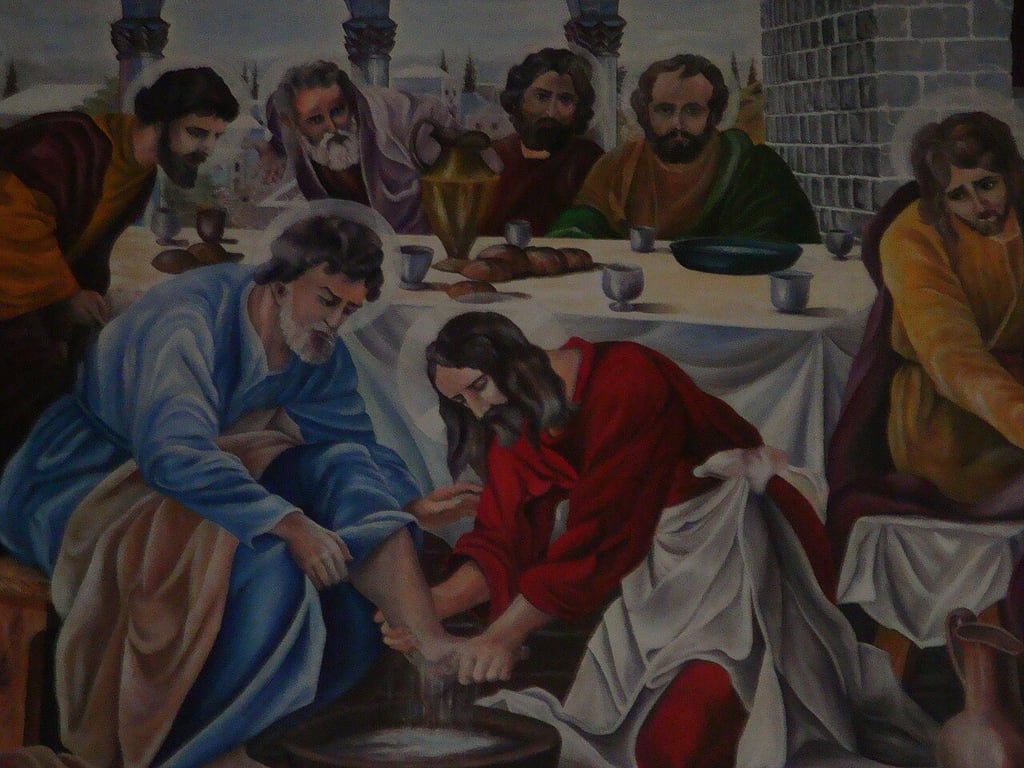 a painting of jesus washing his feet in a bowl