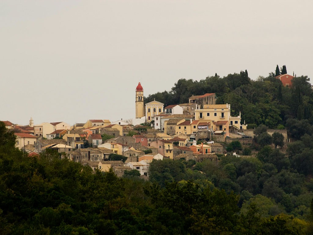 a hill with a church and a clock tower