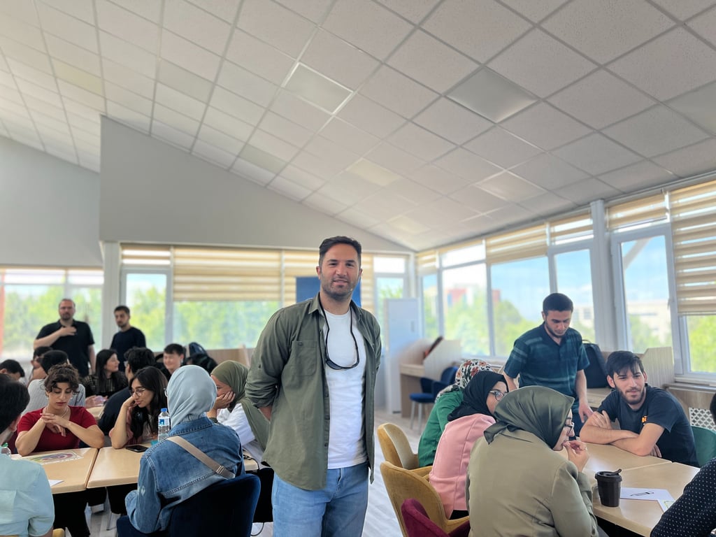 a man standing in a room with a bunch of people