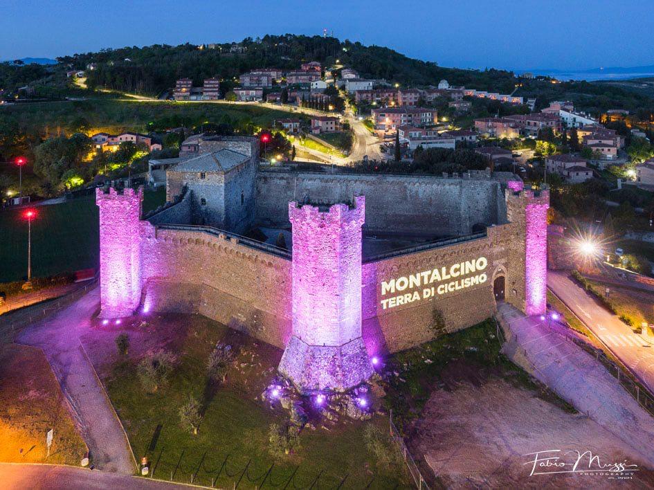 The medieval Montalcino Fortress illuminated in pink for the Giro d'Italia cycling race.