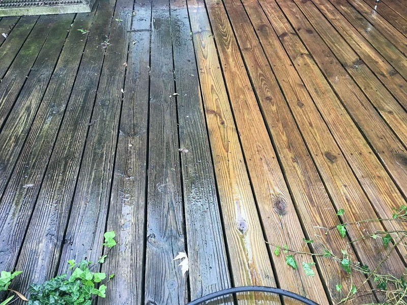A wooden deck cleaned 50/50 to show the difference