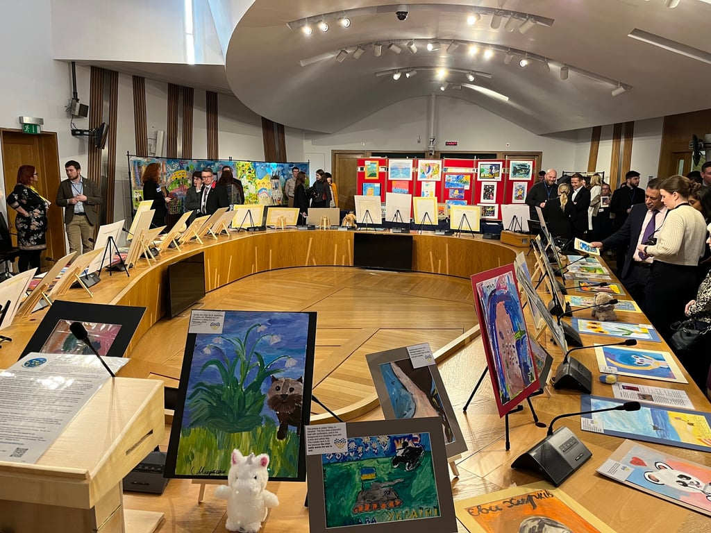 Politicians looking at the exposition with paintings created by children in the Ukrainian war