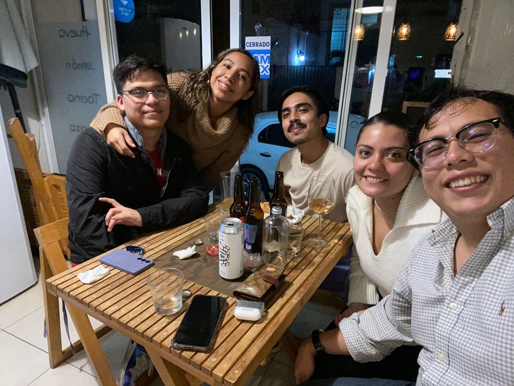 a group of people sitting at a table with drinks