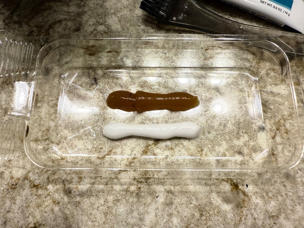 Color base and developer squeezed into tray before mixing for at home eyebrow tint.