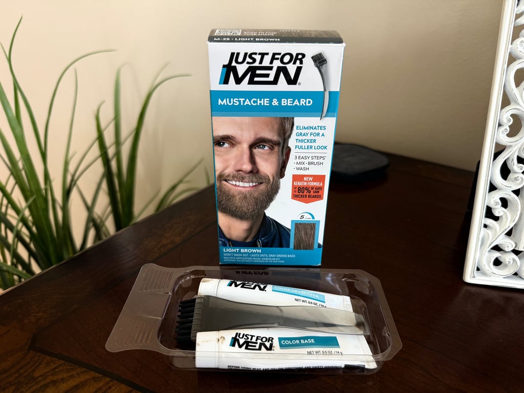 Just For Men Mustache and Beard Light Brown kit displayed on a table for eyebrow tinting at home.