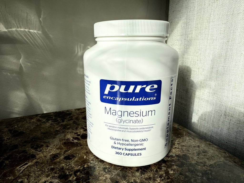 Bottle of magnesium glycinate on an end table ready for a relaxing nighttime routine
