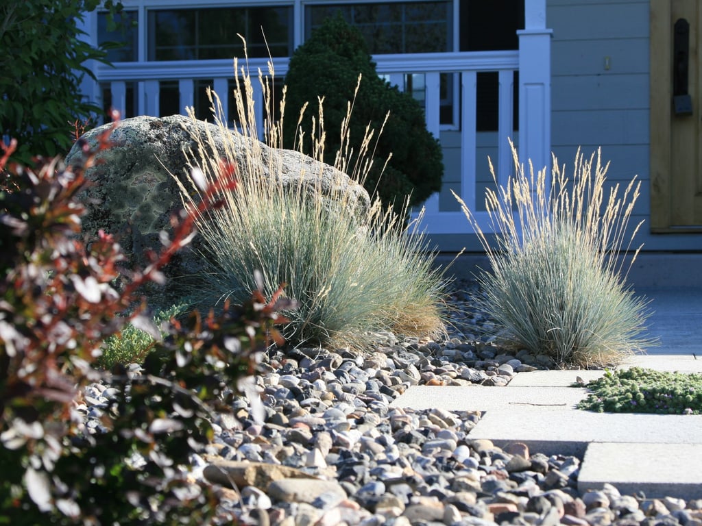 a house with a rock garden and a stone path